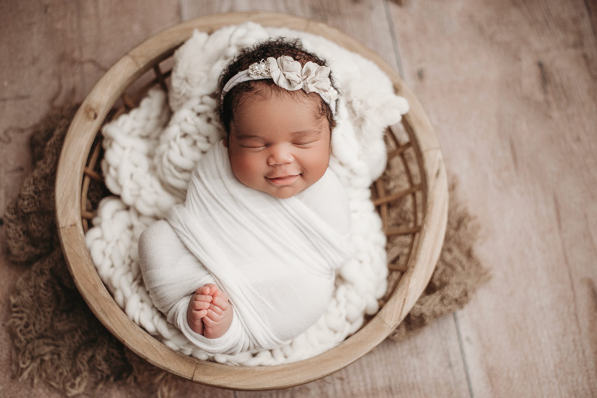 DSC_3615 newborn baby girl posed in a bowl for her newborn photoshoot in a nebraska studio. Baby in a bowl prop, baby girl smiling for her newborn photography session, nebraska newborn photography