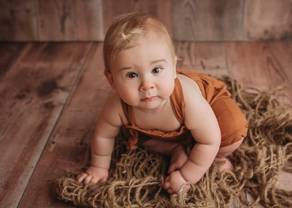baby boy in brown photographed during his milestone session, studio portrait session in lincoln ne, hickman ne baby photographer, photoshoot in studio, outfits included in every photography session