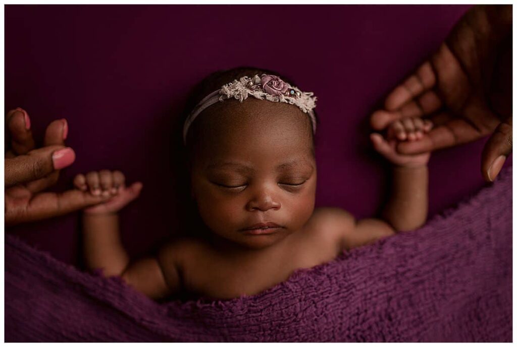 baby girl holding parents hands, purple newborn girl set up, simple newborn poses, poses with newborn and parents, newborn photography, newborn portrait session, baby photographer atlanta