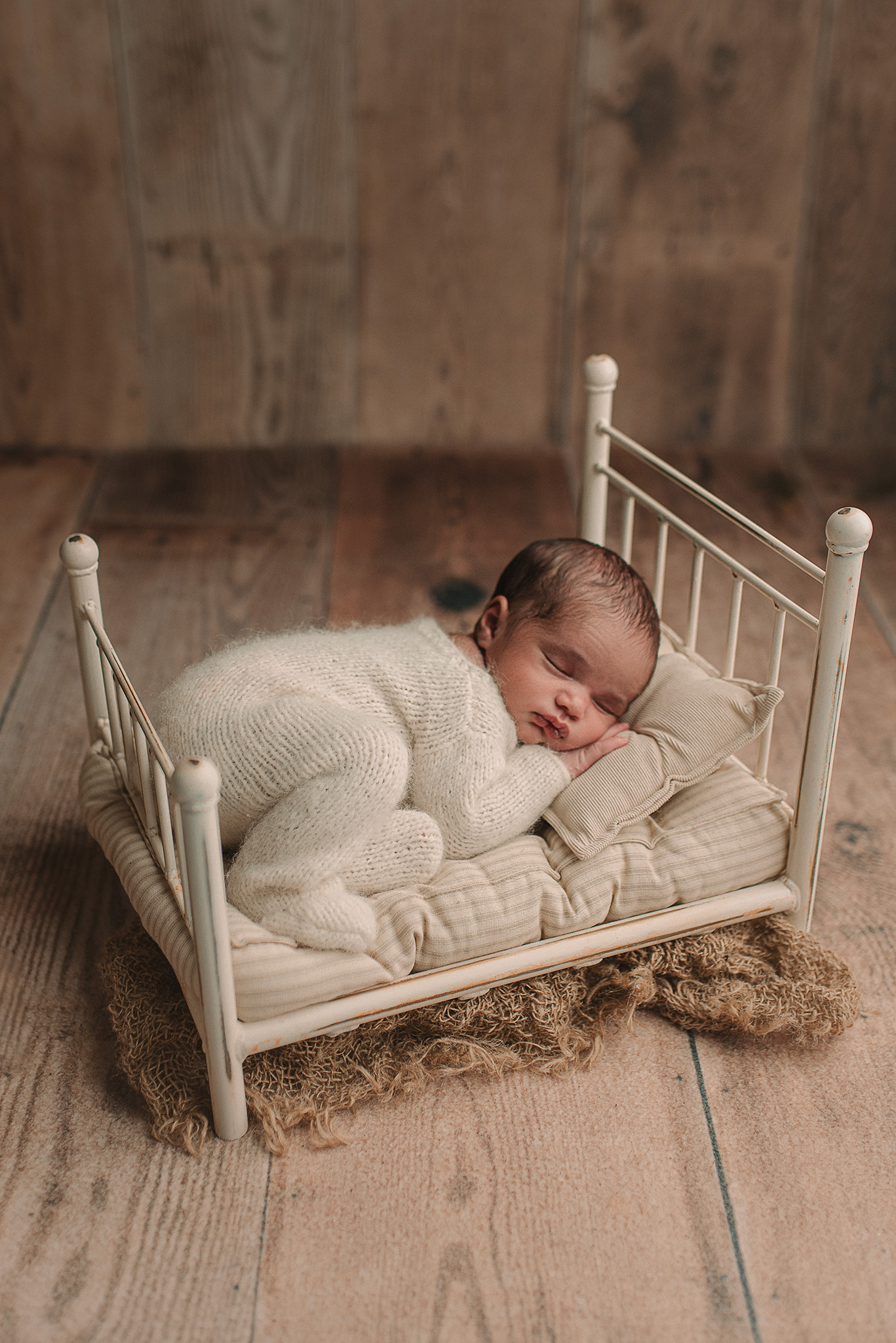 newborn boy posed in prop bed for photography session, newborn photoshoot lnk, in home newborn photography nebraska