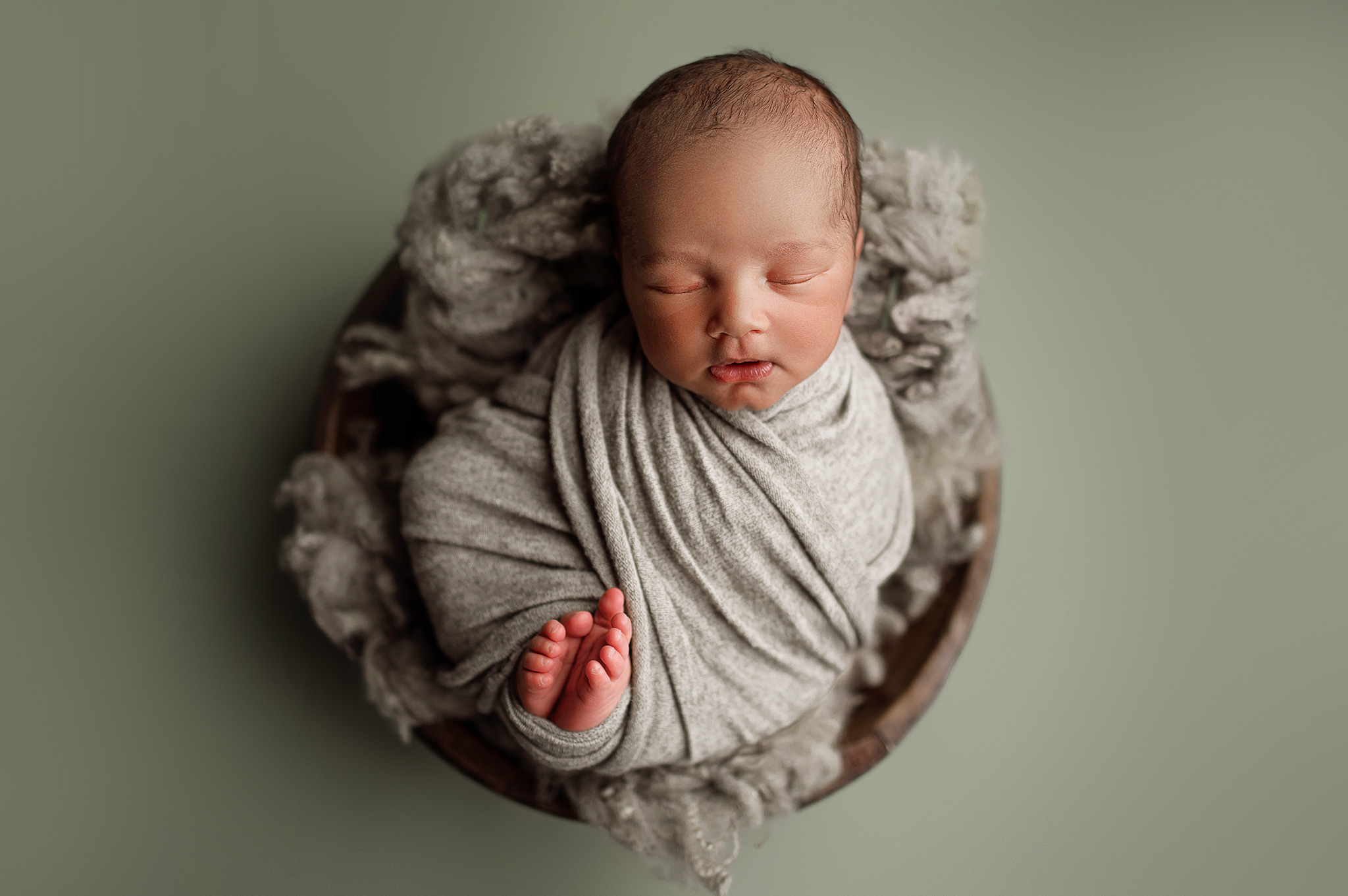 baby boy posed in a bowl for his newborn session, newborn photography lincoln, lincoln nebraska photos, nebraksa photographers, newborn boy, bryan health
