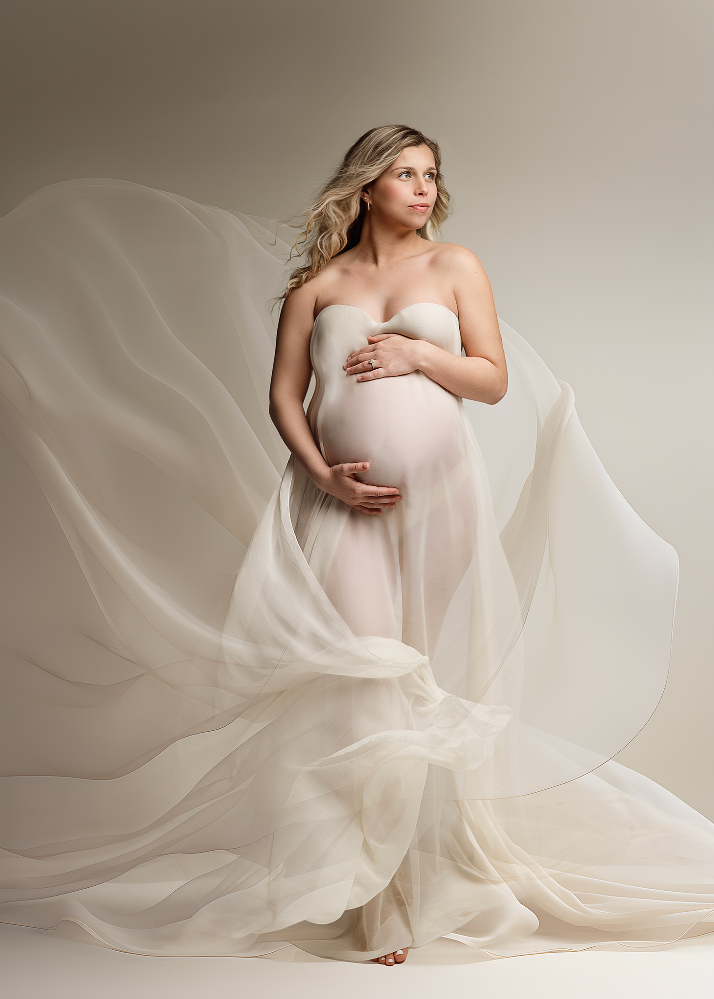 mom to be posed in nebraska photography studio using flowing fabric, nebraska maternity photographer, maternity photographer omaha, lincoln ne maternity photoshoot