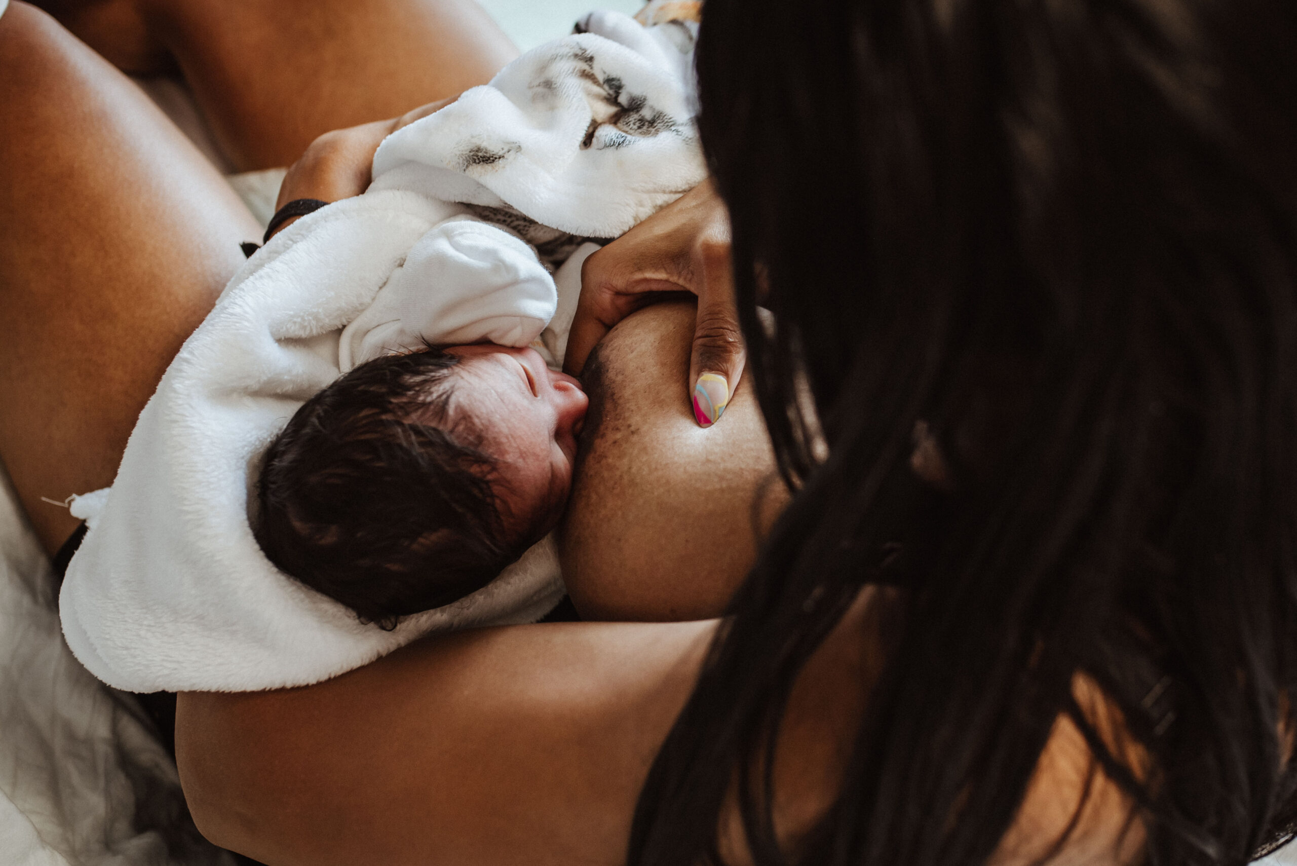 breastfeeding mom in the hospital with her newborn baby boy