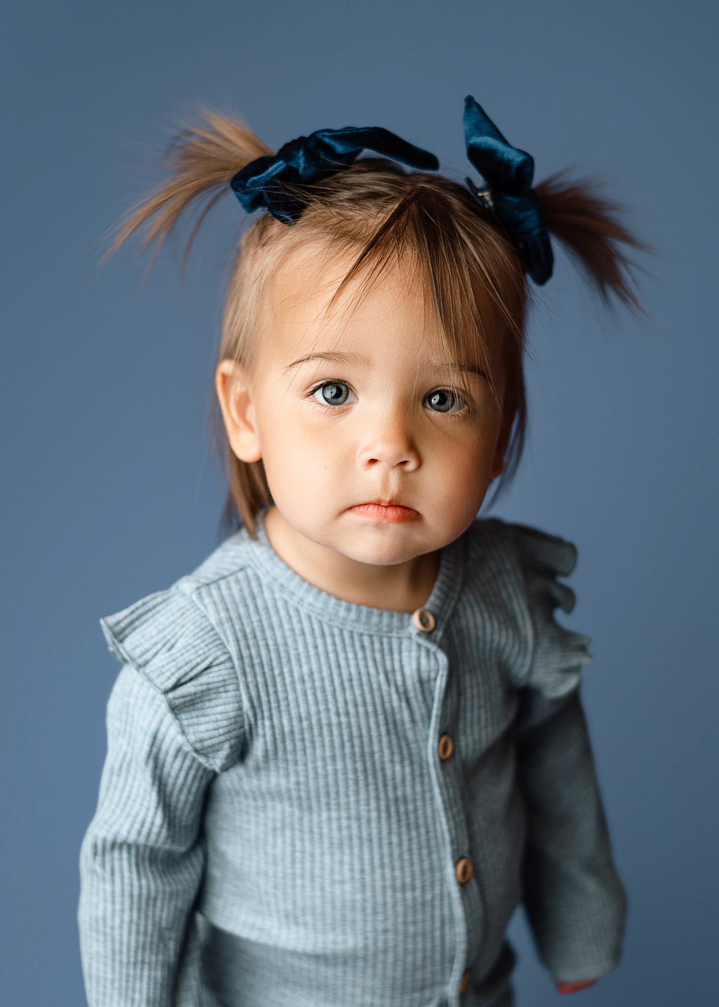 toddler girl with pigtails for milestone session, 1 year old session in the studio, childrens portaits