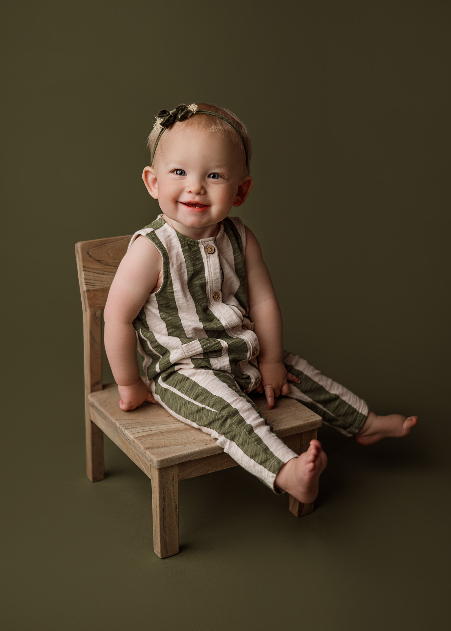 little girl wearing green stripes for photoshoot in nebraska studio, best baby photographer in lincoln, waverly baby portraits, crete nebraska photographer