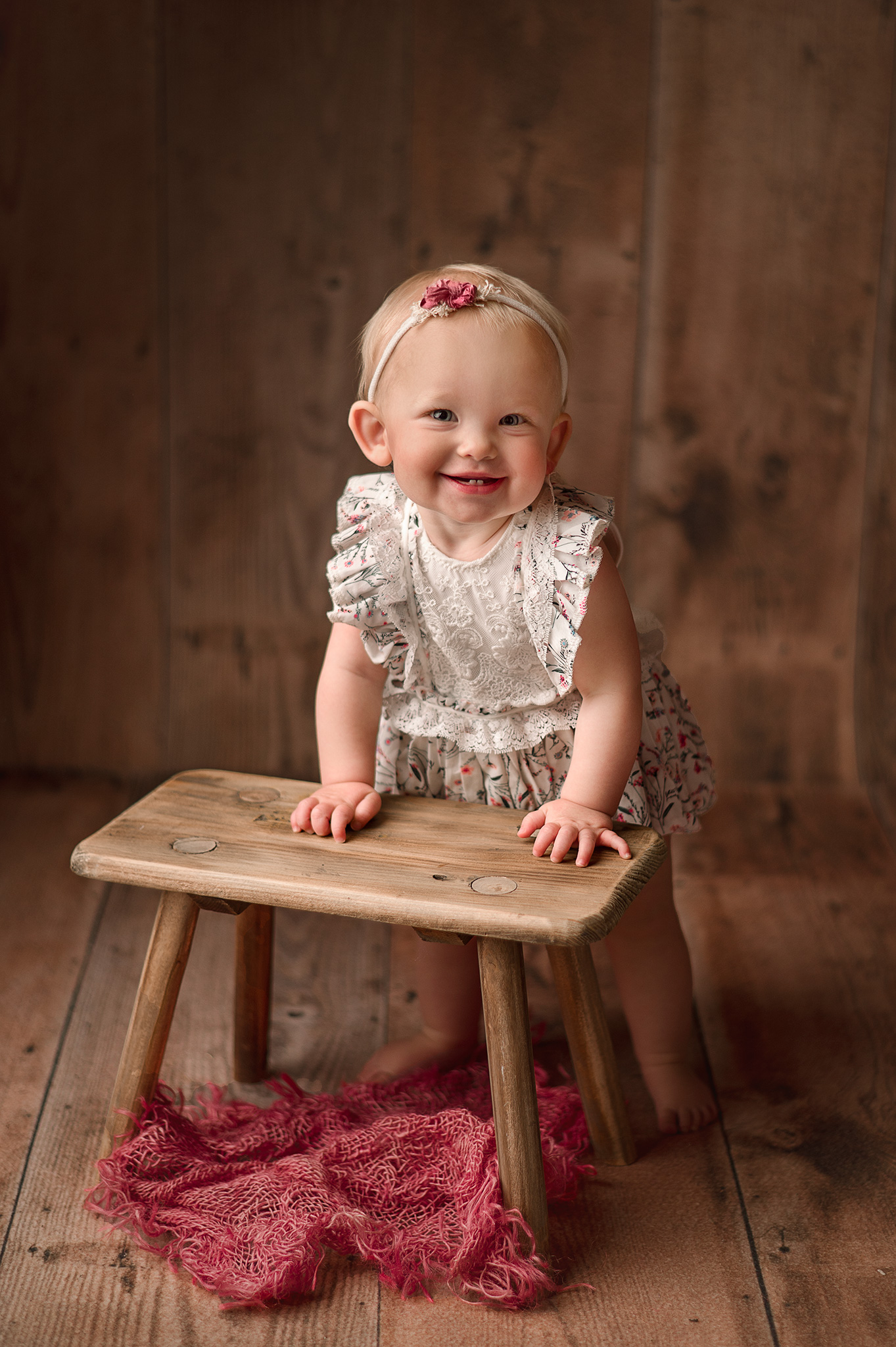 sweet babygirl posing on a wooden stool for her 9 month photography session, lincoln nebraska baby photography, studio photographer with props nebraska, client closet