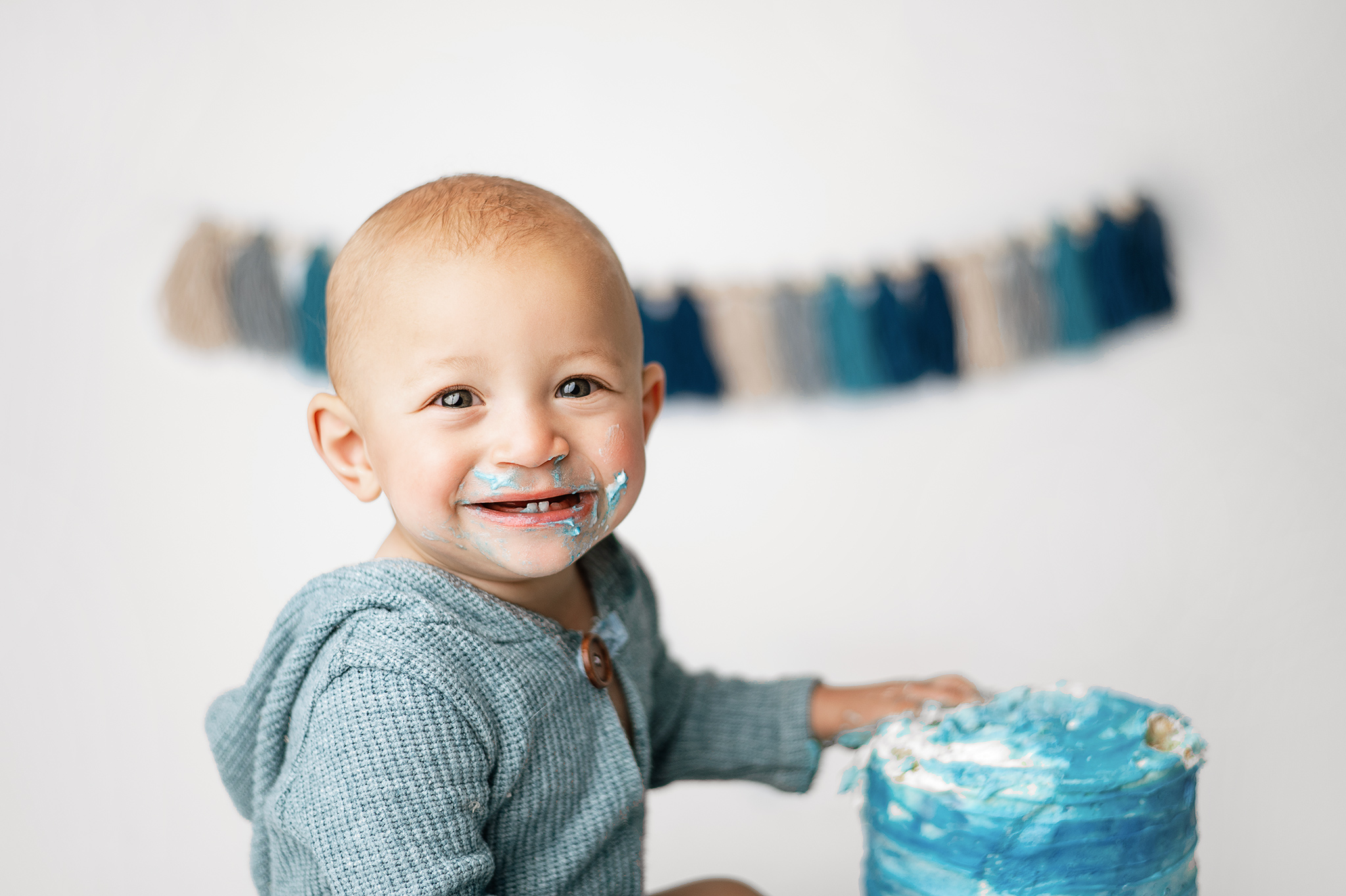 Boy smiling during his birthday photoshoot, cake smash photography, lincoln nebraska photographer