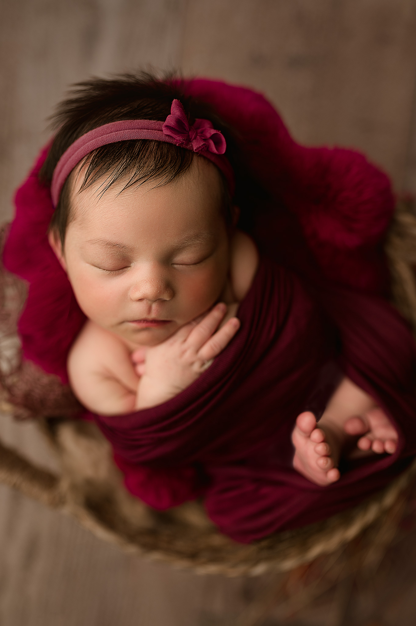 newborn baby girl posed in basket for newborn photo session, newborn photography near me, nebraska newborn photos