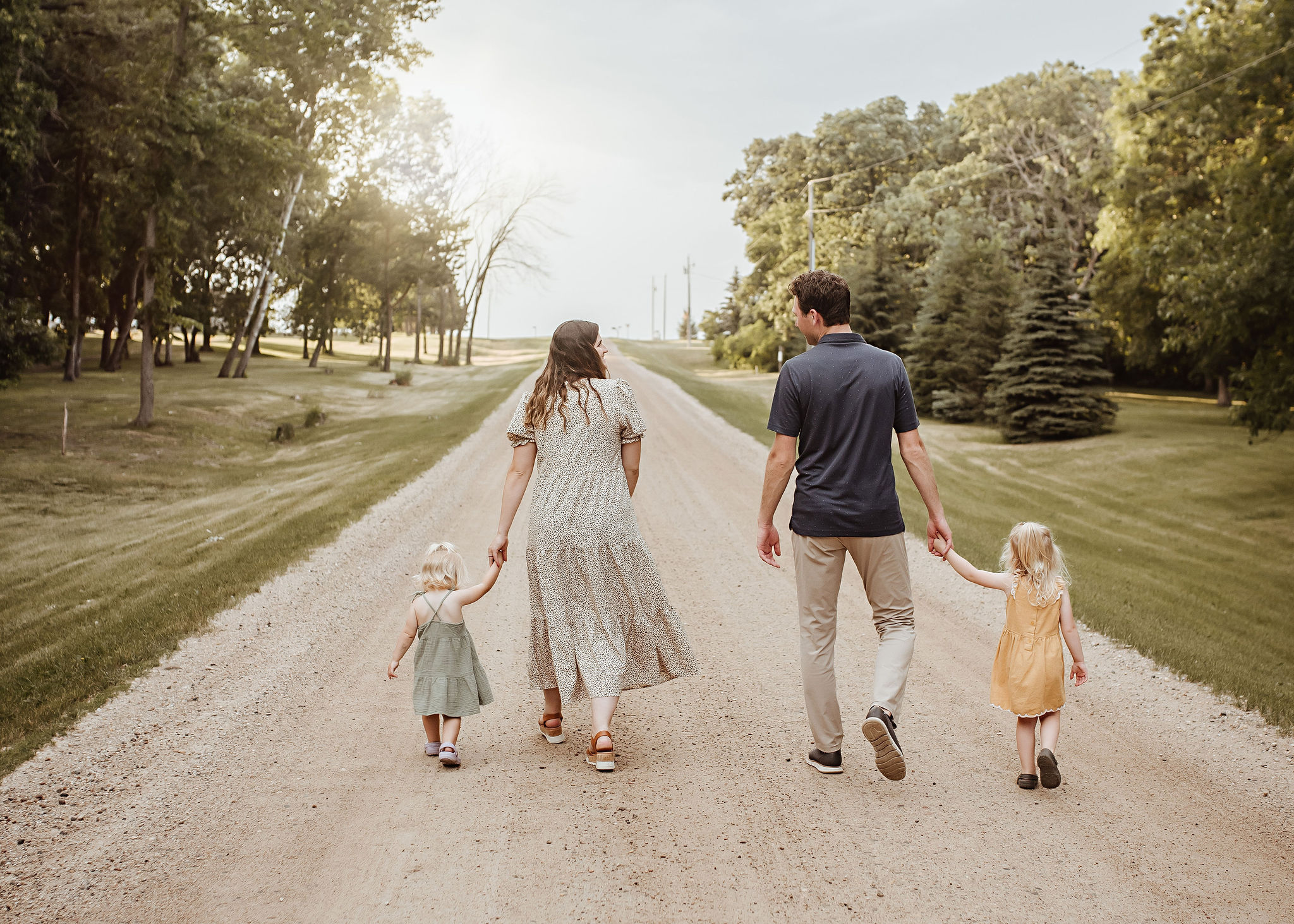 parents walking with kids down dirt road, family photos near me