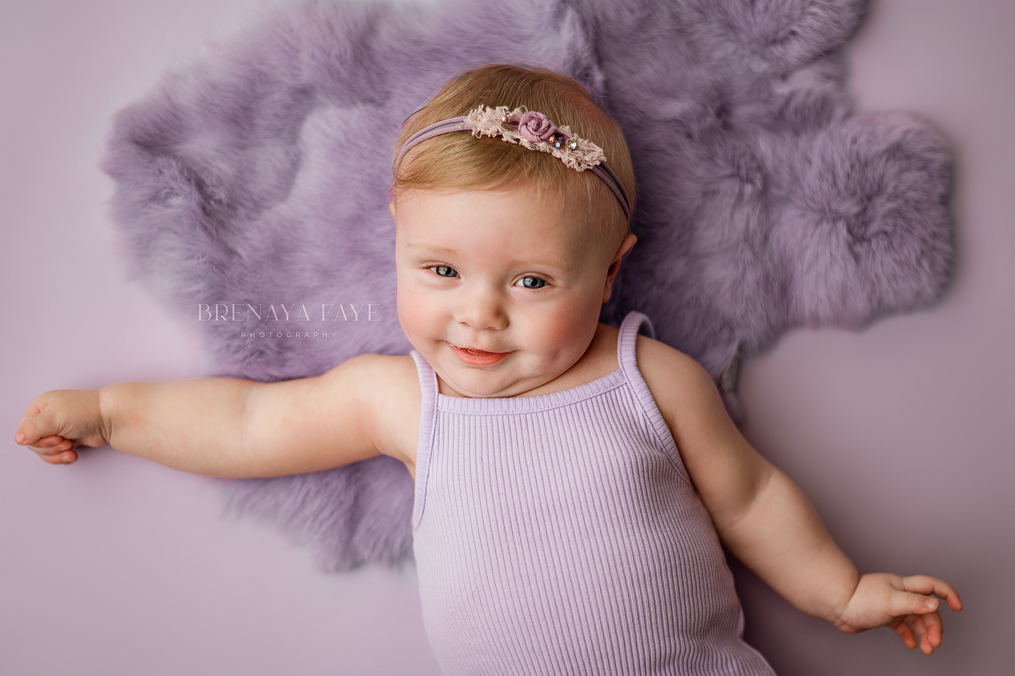 6 month photo session, girl not sitting photoshoot ideas, baby girl on purple for milestone session, sitter session ideas