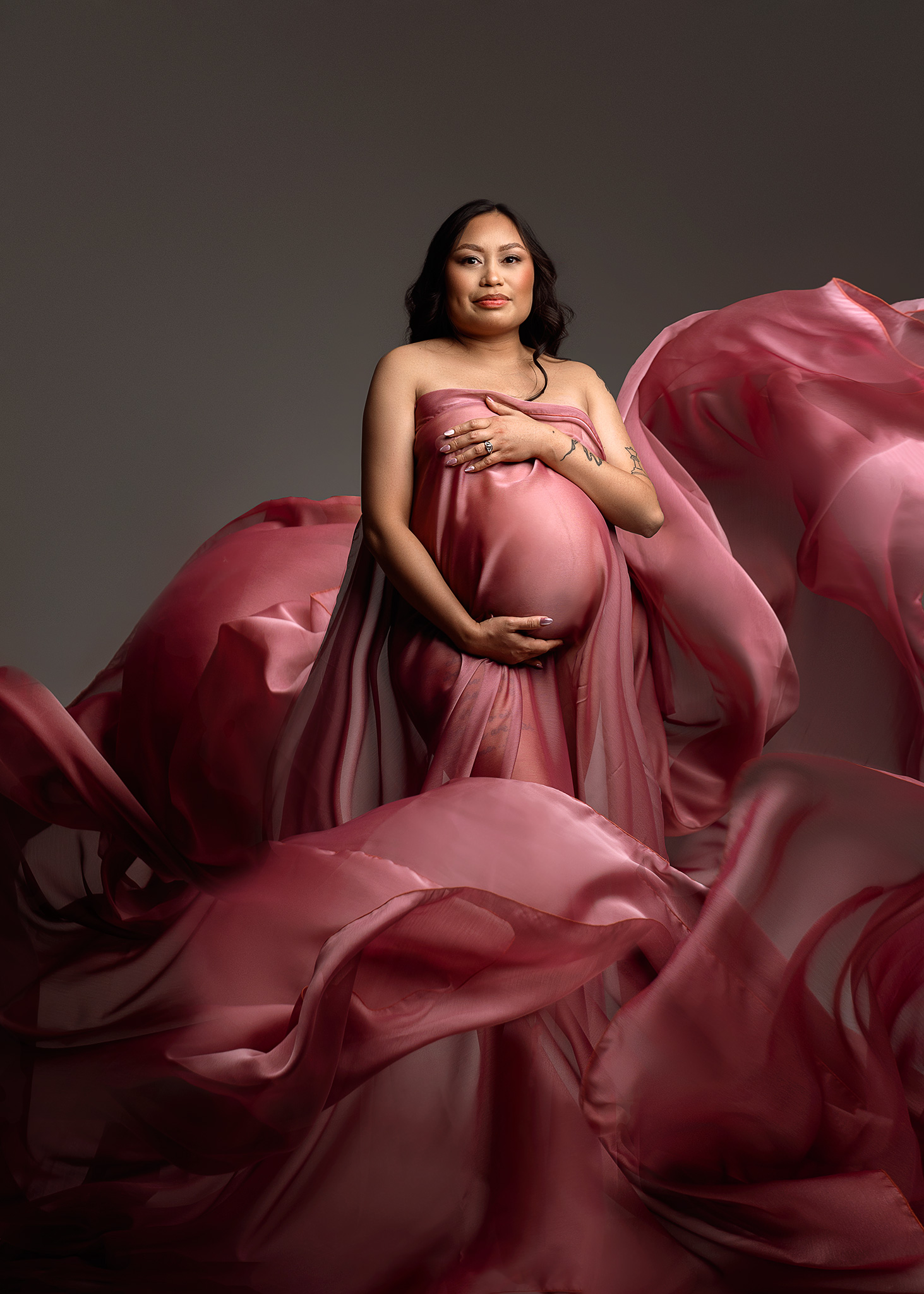 mom to be photographed with pink flying fabric, lincoln nebraska maternity photography, nebraska fine art maternity, studio maternity photography omaha nebraska