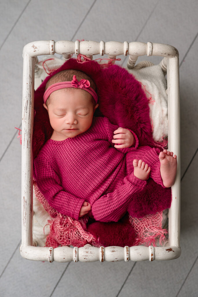 newborn girl photographed in basket for newborn photoshoot in nebraska, lincoln nebraska newborn photographer, full service photography session, Nebraska Photography Studio