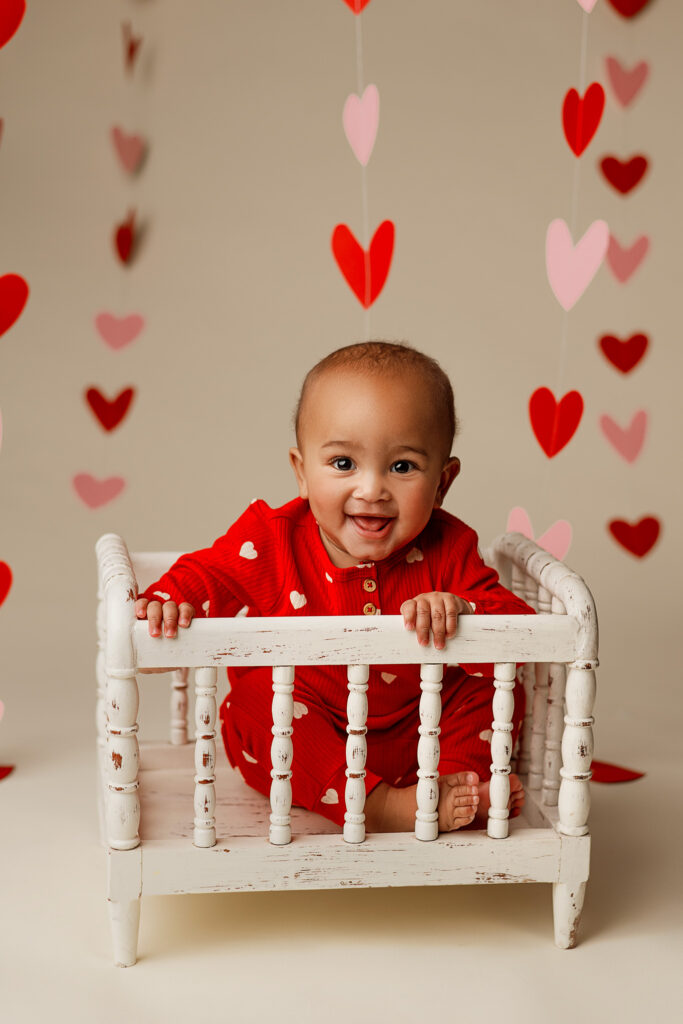 baby boy smiling during valentines photo session with photographer in lincoln nebraska