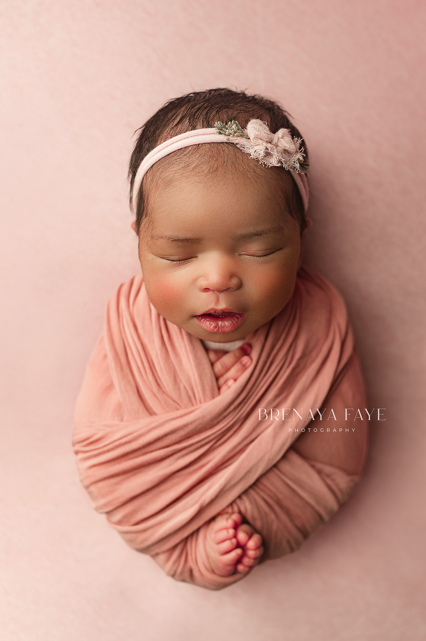 newborn girl in pink wrap with tieback, dog bed newborn poses, nebraska newborn photographer