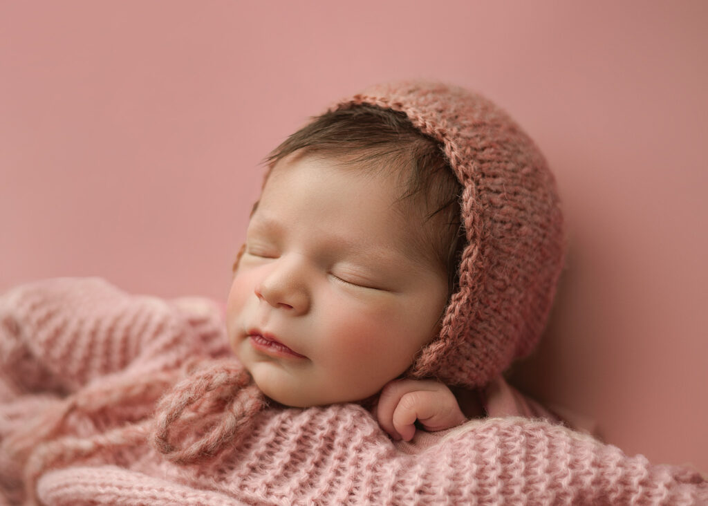 babygirl with a knit bonnet photographed in Lafayette Indiana Studio