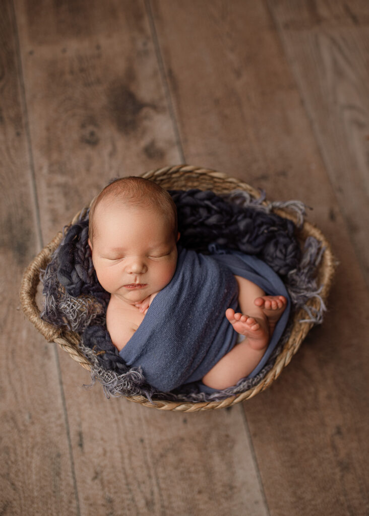 newborn boy in blue professionally photographed in Indiana Mobile studio, photography lafayette indiana, lafayette-indiana-photographers