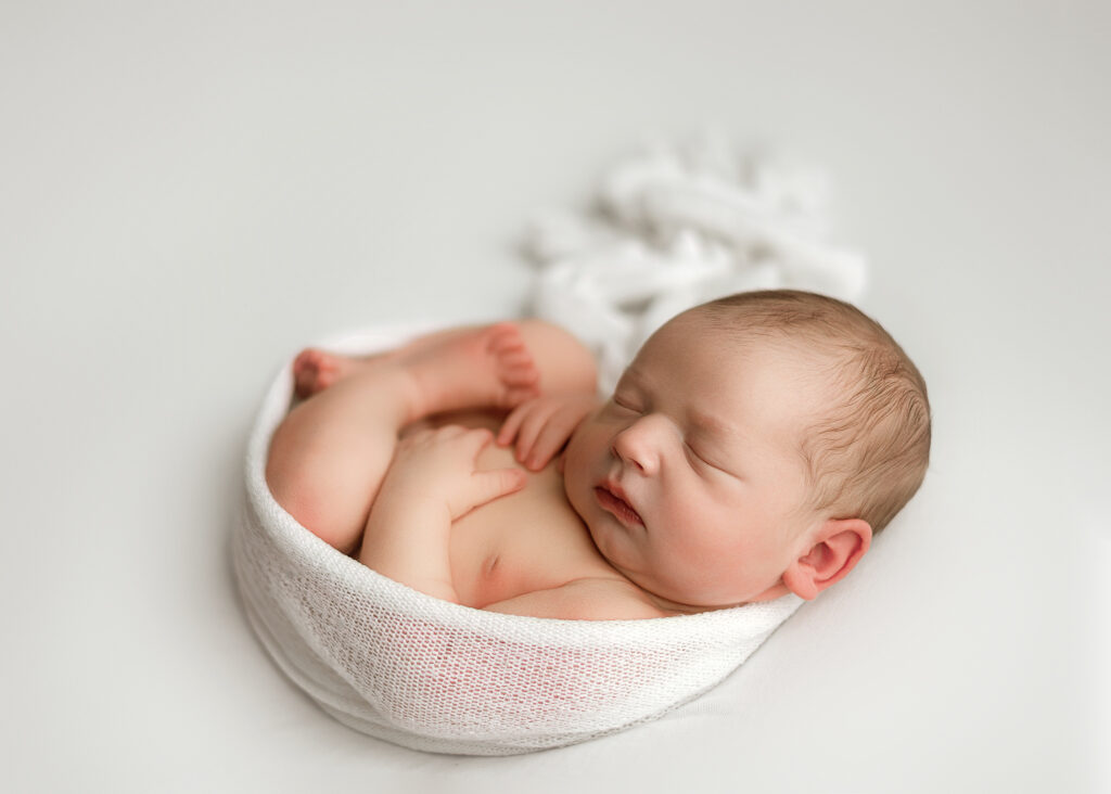 west lafayette newborn photographer, luxury photographer in indiana, in home studip newborn photography, photography lafayette indiana, baby boy photographed in white for his professional newborn session
