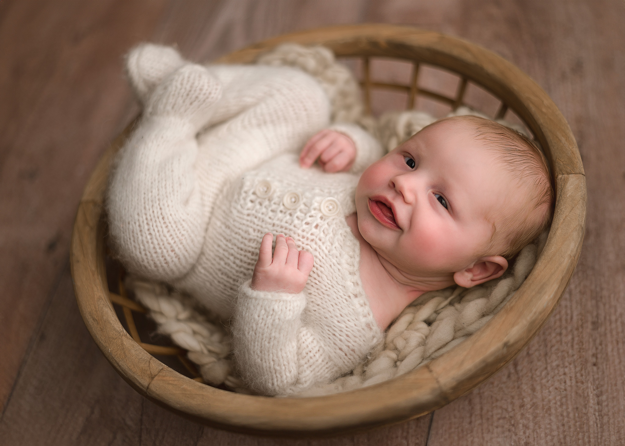 newborn photographer Frankfort indiana, baby boy smiling wearing neutral clothing provided by photographer