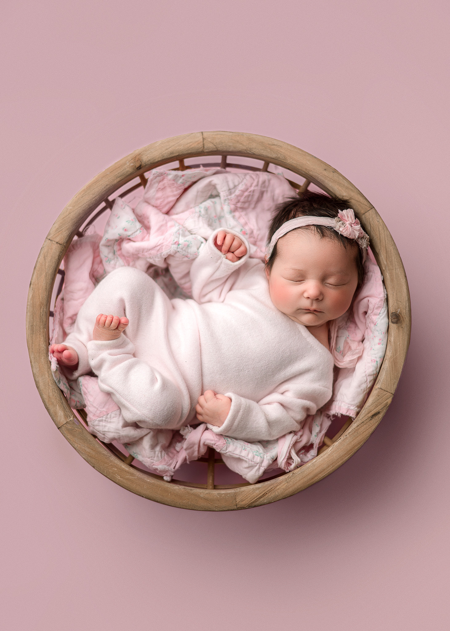 newborn photographer Crawfordsville, baby girl photographed in pink during studio newborn portrait session.