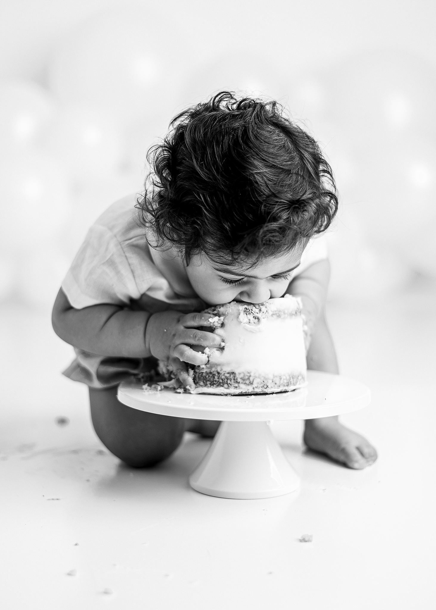 cakesmashphotographerlafayetteIN baby boy going face first into his smash cake photographed in a professional studio for his first birthday session