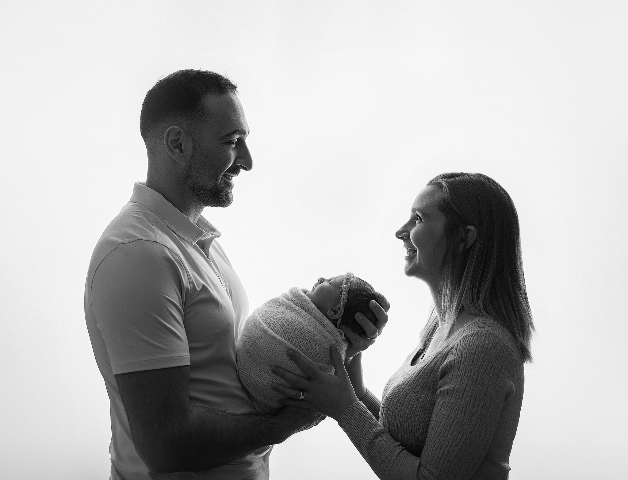new mom holding baby during an in home studio newborn session in west lafayette indiana
