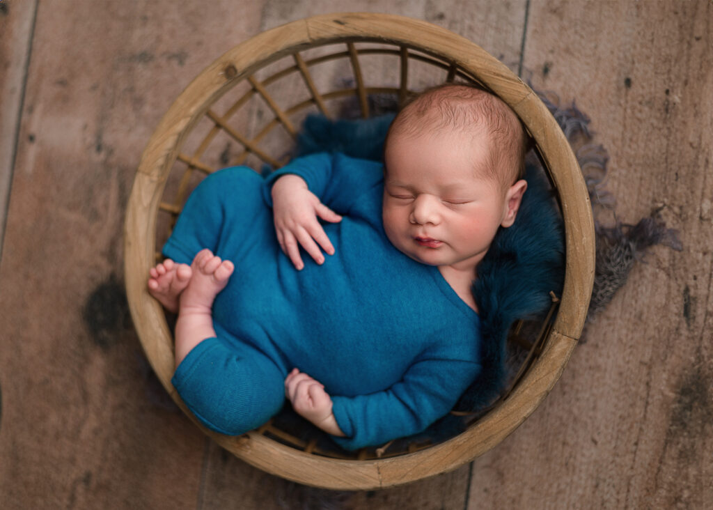 newborn boy in bowl prop for studio session done in clients home