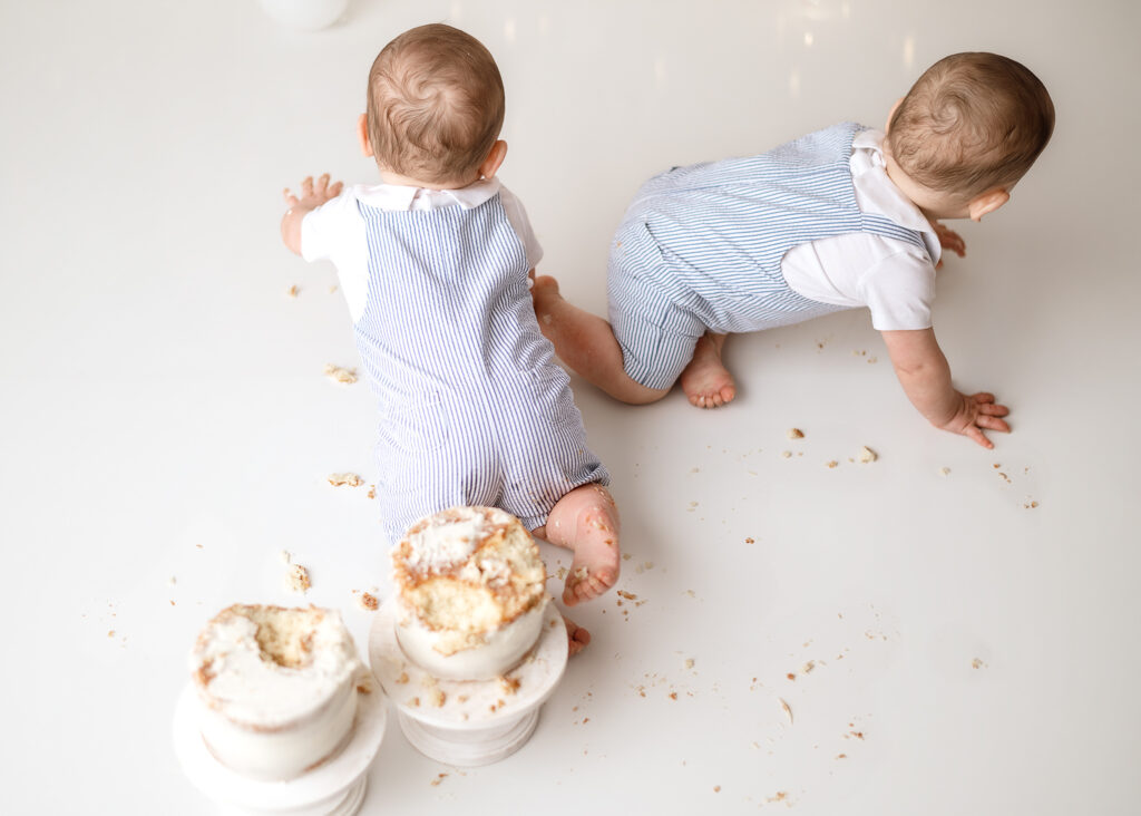 boys crawling away at smash cake session in Indiana