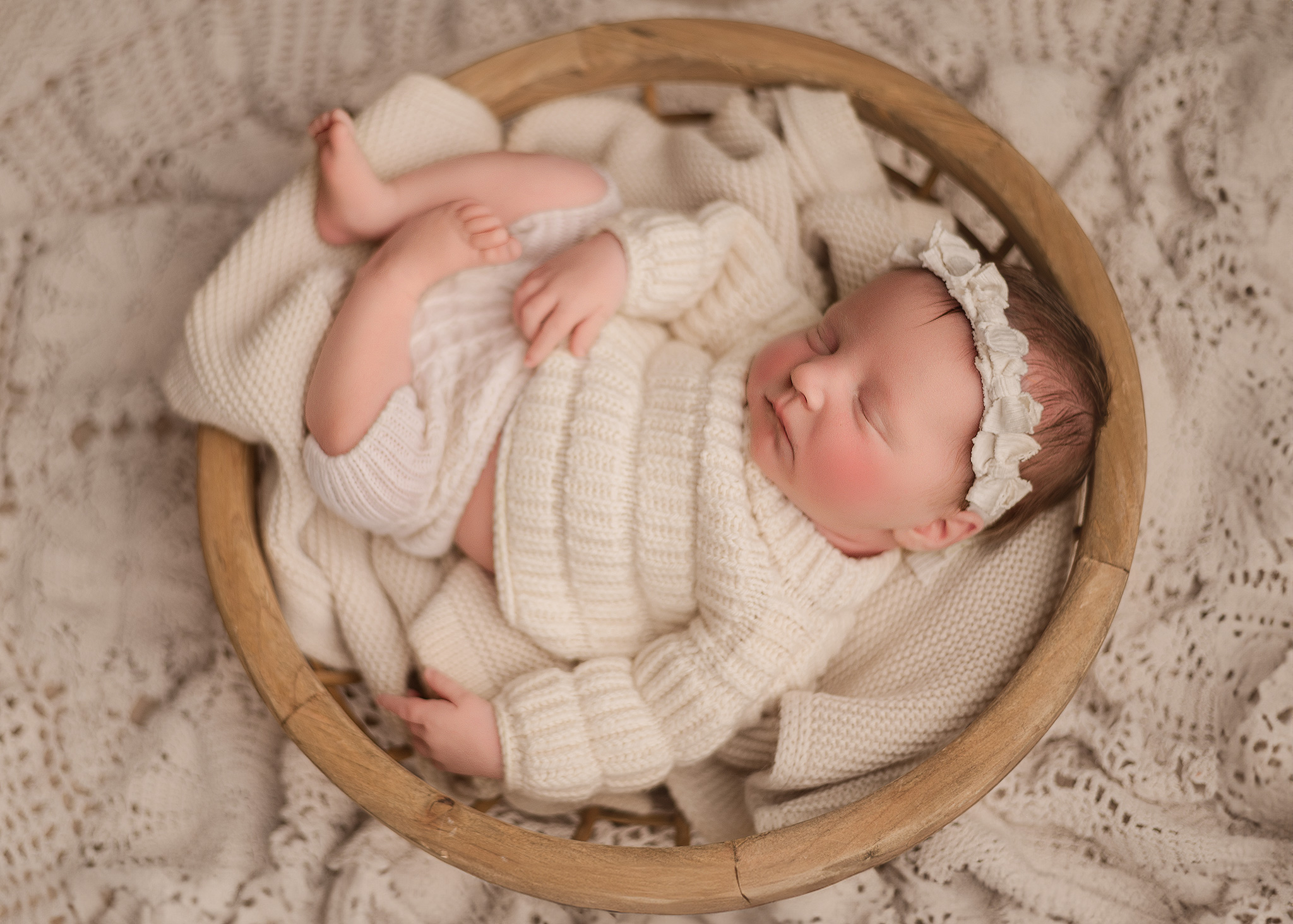 Babygirl photographed in round bowl using boho layers for photography session in central indiana home