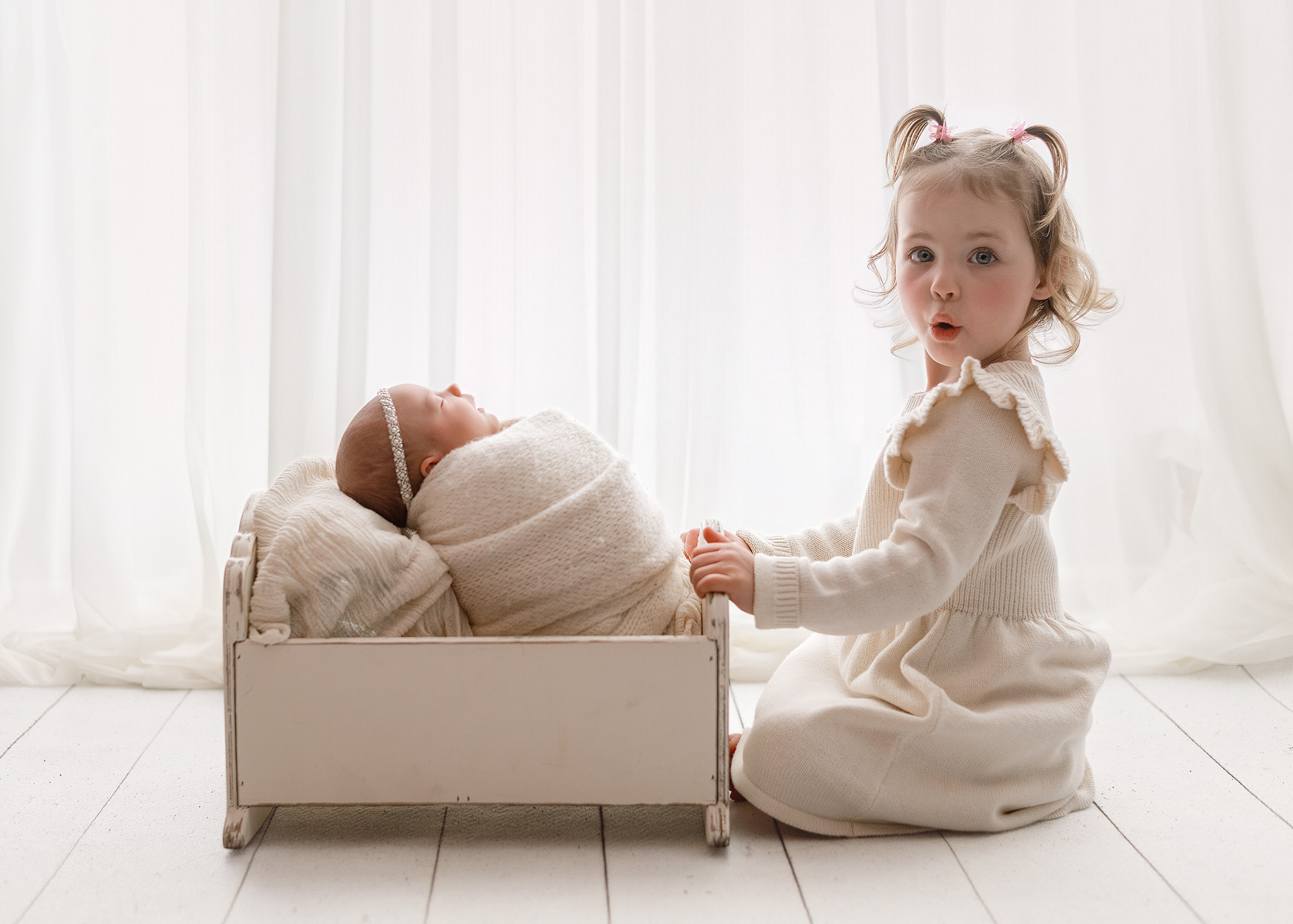 big sister and newborn posed in indiana home