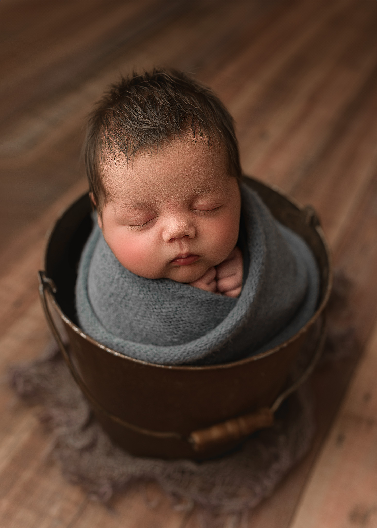 Studio style newborn portrait photographed inside the family's home
