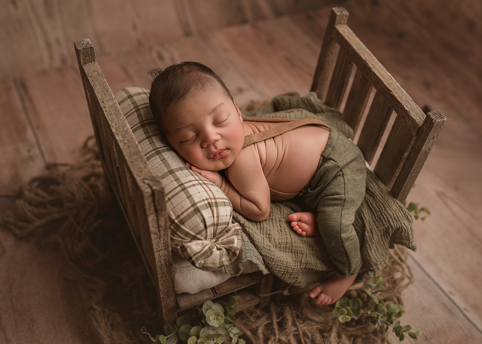 baby photographed on prop in home