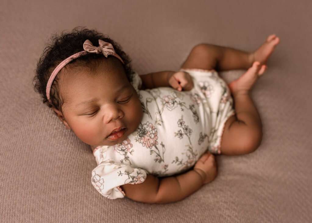 newborn baby girl photographed in her home for newborn portrait session in indiana