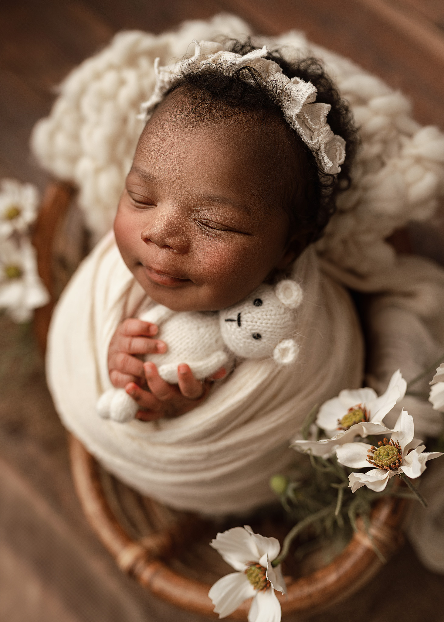 newborn smiling while being photographed by an indianapolis photographer