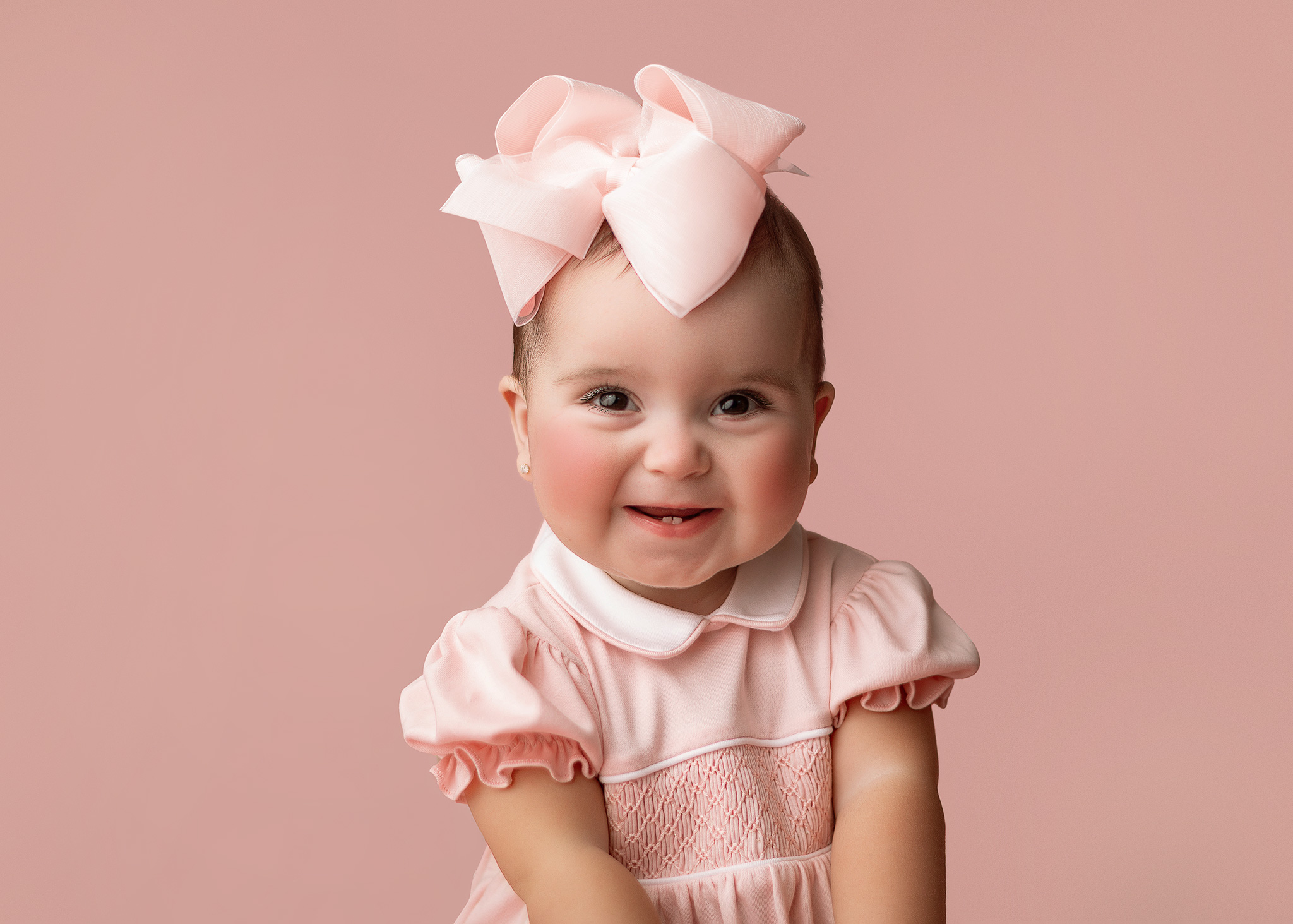 One year old baby girl in light pink during an in-home first birthday photography session serving Indianapolis families